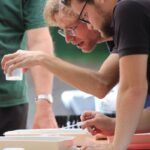 Volunteers examining river samples during a hands-on learning activity.
