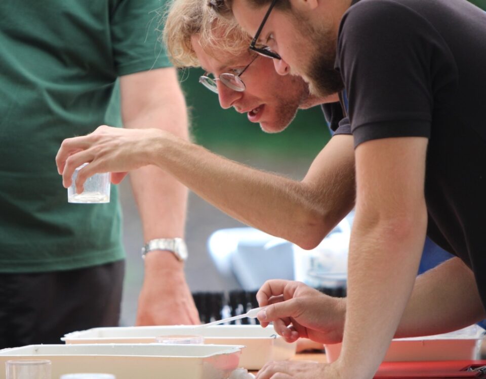 Volunteers examining river samples during a hands-on learning activity.